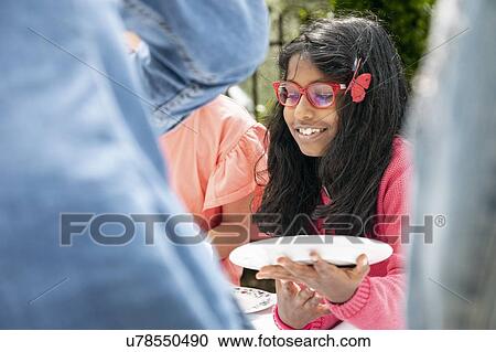 Young girl with plate at outdoor family lunch, Florence, Italy View Large Photo Image Stock Image - Young girl with plate at outdoor family lunch, Florence, Italy. Fotosearch