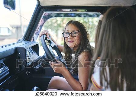 Young girls pretending to drive View Large Photo Image Stock Image - Young girls pretending to drive. Fotosearch