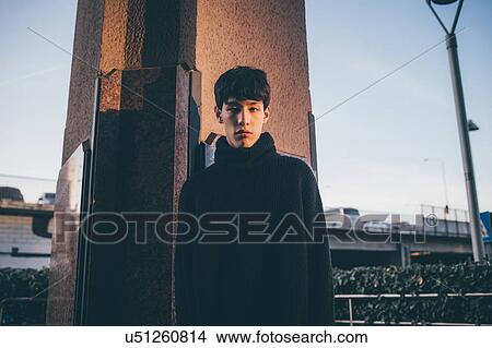 Young man, pillar in background, Milan, Italy View Large Photo Image Picture - Young man, pillar in background, Milan, Italy. Fotosearch