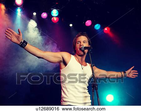 Stock Photograph - Young Man Singing at rock Concert. Fotosearch