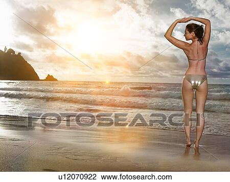 Stock Image - Young sexy woman in bikini on beack. Fotosearch