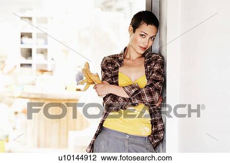 Stock Image - Young Woman artist in her creative studio. Fotosearch