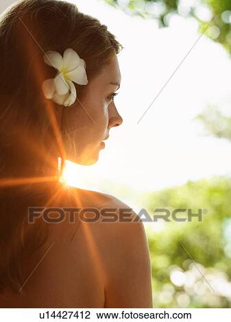 Stock Image - Young Woman in Bikini with Flower in Hair. Fotosearch