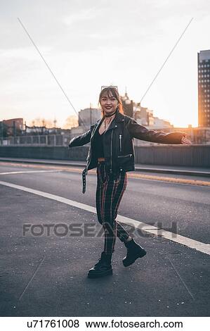 Young woman in punk style posing in street, Milan, Italy View Large Photo Image Stock Photo - Young woman in punk style posing in street, Milan, Italy. Fotosearch