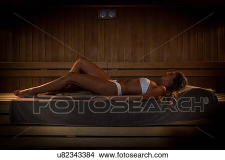 Young woman relaxing in sauna room View Large Photo Image Picture - Young woman relaxing in sauna room. Fotosearch
