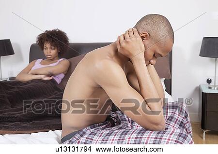African American couple in bedroom ignoring each other View Large Photo Image Picture - African American couple in bedroom ignoring each other. Fotosearch