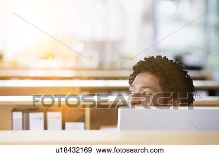 Stock Photo - African American Man using computer in office. Fotosearch