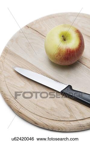 Apple and knife on wooden plate over white background View Large Photo Image Stock Photograph - Apple and knife on wooden plate over white background. Fotosearch
