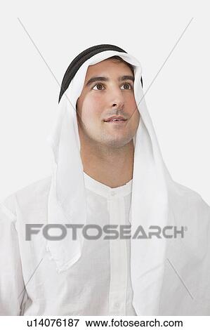 Arab businessman looking away against white background View Large Photo Image Stock Photo - Arab businessman looking away against white background. Fotosearch