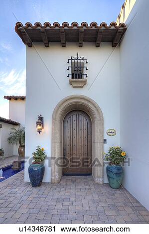 Stock Image - Arched doorway to luxury villa. Fotosearch