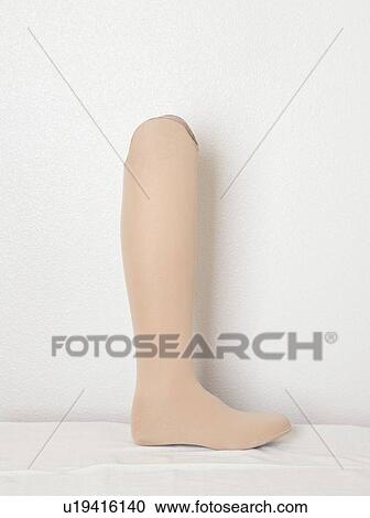 Stock Image - Artificial leg over gray wall. Fotosearch