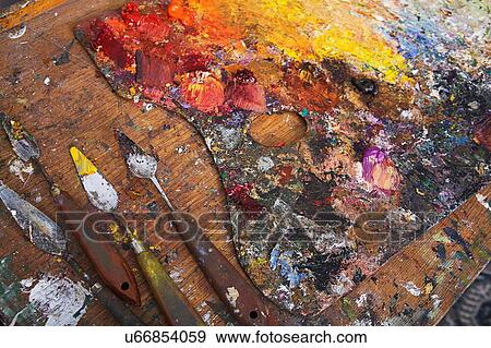Stock Photo - Artist's Palette and Palette Knives Covered in Paint. Fotosearch