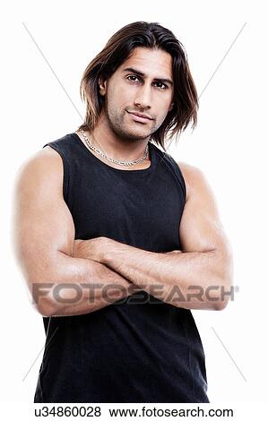 Stock Photo - Attractive indian man with arms folded in studio. Fotosearch