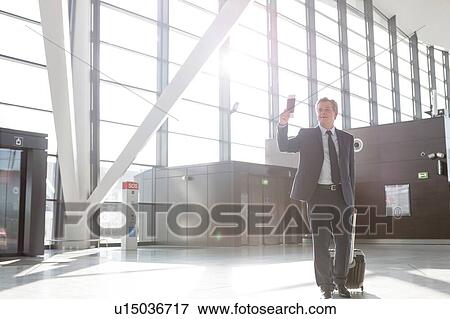 Attractive mature businessman walking through his gate for boarding in airport View Large Photo Image Stock Photo - Attractive mature businessman walking through his gate for boarding in airport. Fotosearch