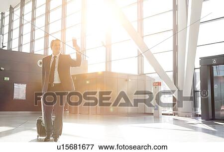 Attractive mature businessman walking through his gate for boarding in airport View Large Photo Image Stock Photo - Attractive mature businessman walking through his gate for boarding in airport. Fotosearch