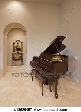 Stock Photo - Baby grand piano in corner of luxury home. Fotosearch
