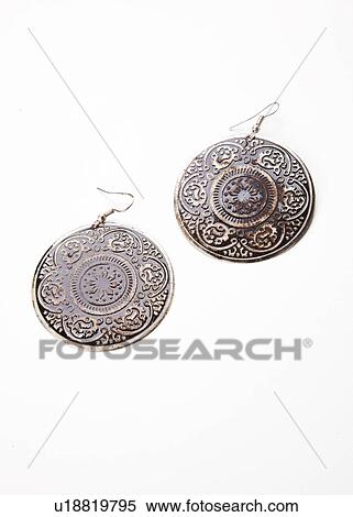 Stock Photography - Beautiful design on earrings over white background. Fotosearch
