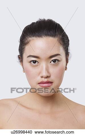 Stock Image - Beauty portrait of smiling young Chinese woman over white background. Fotosearch