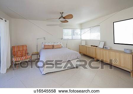 Stock Photo - Bedroom interior with lots of natural light. Fotosearch