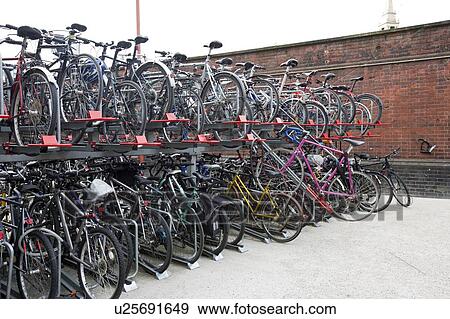 Stock Photo - Bicycles parked in storage racks. Fotosearch