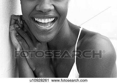 Stock Image - Black and white cropped portrait of african american woman smiling. Fotosearch