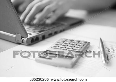 Stock Photography - Black and white photo of man doing taxes and working from home. Fotosearch
