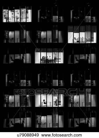 Stock Photo - Black and white photo of office buiilding at night time. Fotosearch