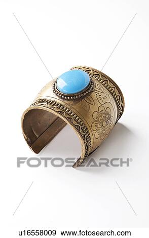 Blue gem on traditional bracelet over white background View Large Photo Image Stock Photo - Blue gem on traditional bracelet over white background. Fotosearch