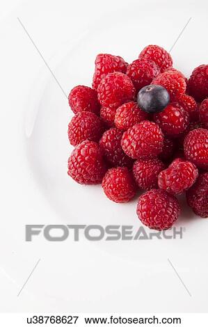 Stock Photo - Blueberry over raspberries against white background. Fotosearch