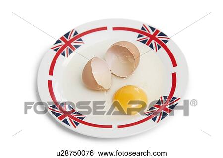 Stock Photograph - Broken brown egg on plate over white background. Fotosearch