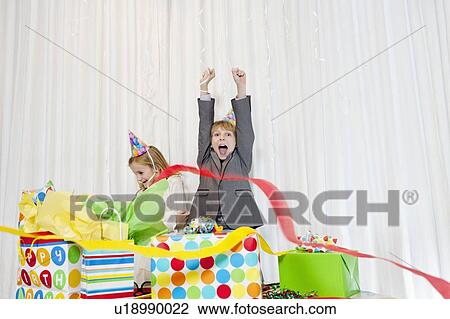 Brothers and sister enjoying at birthday party View Large Photo Image Stock Image - Brothers and sister enjoying at birthday party. Fotosearch