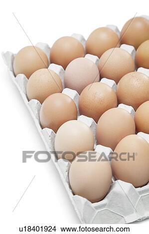 Picture - Brown eggs arranged in carton over white background. Fotosearch