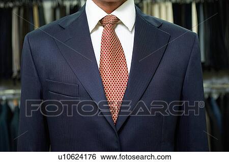 Stock Photograph - Business man wearing suit in shop. Fotosearch