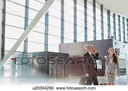 Stock Image - Business people arriving in airport . Fotosearch