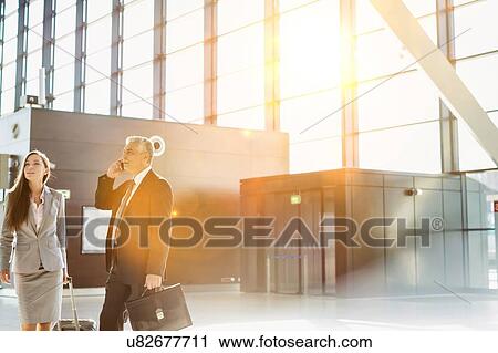 Stock Image - Business people arriving in airport . Fotosearch
