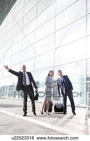 Business people calling for taxi in the airport View Large Photo Image Stock Photo - Business people calling for taxi in the airport. Fotosearch