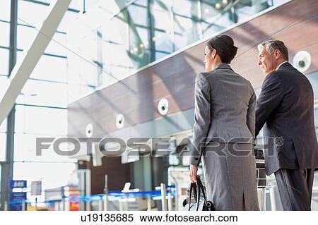 Business people checking their bags in airport View Large Photo Image Stock Photography - Business people checking their bags in airport. Fotosearch