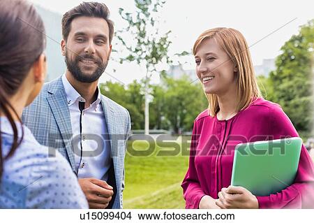Picture - Business people discussing plans on meeting outdoor. Fotosearch
