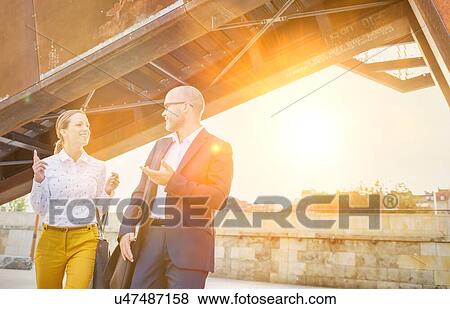 Business people discussing plans over document View Large Photo Image Stock Photo - Business people discussing plans over document. Fotosearch