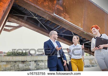 Stock Photography - Business people discussing plans over document. Fotosearch