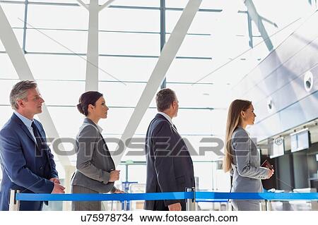 Picture - Business people queueing for check in at airport. Fotosearch