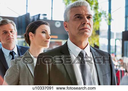 Business people queueing for check in airport View Large Photo Image Stock Image - Business people queueing for check in airport. Fotosearch