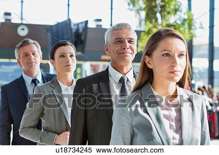 Stock Photography - Business people queueing for check in airport. Fotosearch