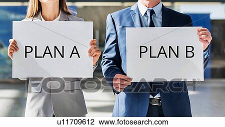 Business people standing while holding PLAN A and PLAN B white placard View Large Photo Image Stock Image - Business people standing while holding PLAN A and PLAN B white placard. Fotosearch