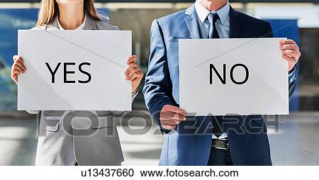 Business people standing while holding white YES or NO placard View Large Photo Image Stock Image - Business people standing while holding white YES or NO placard . Fotosearch