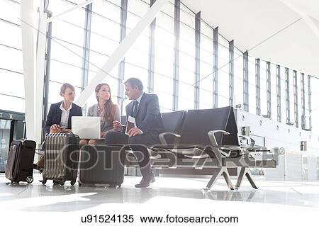 Business people working while waiting for boarding in the airport View Large Photo Image Stock Photography - Business people working while waiting for boarding in the airport. Fotosearch