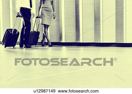Stock Photo - Businessman and businesswoman attending business conference in a hotel. Fotosearch
