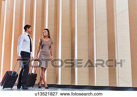 Stock Photo - Businessman and businesswoman attending business conference in a hotel. Fotosearch