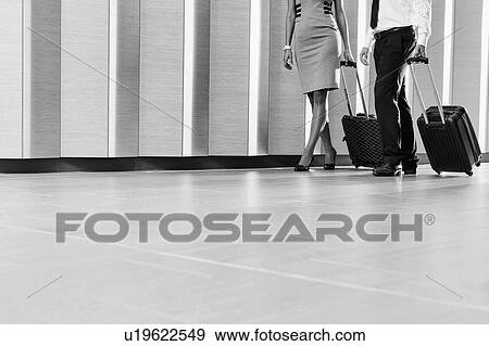 Stock Photo - Businessman and businesswoman attending business conference in a hotel. Fotosearch