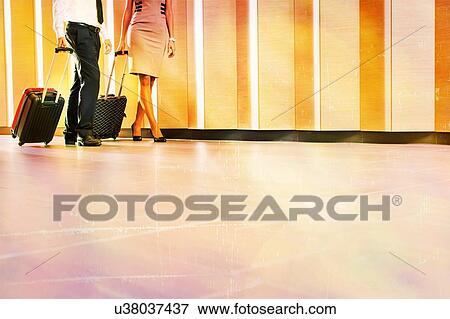 Stock Photo - Businessman and businesswoman attending business conference in a hotel. Fotosearch